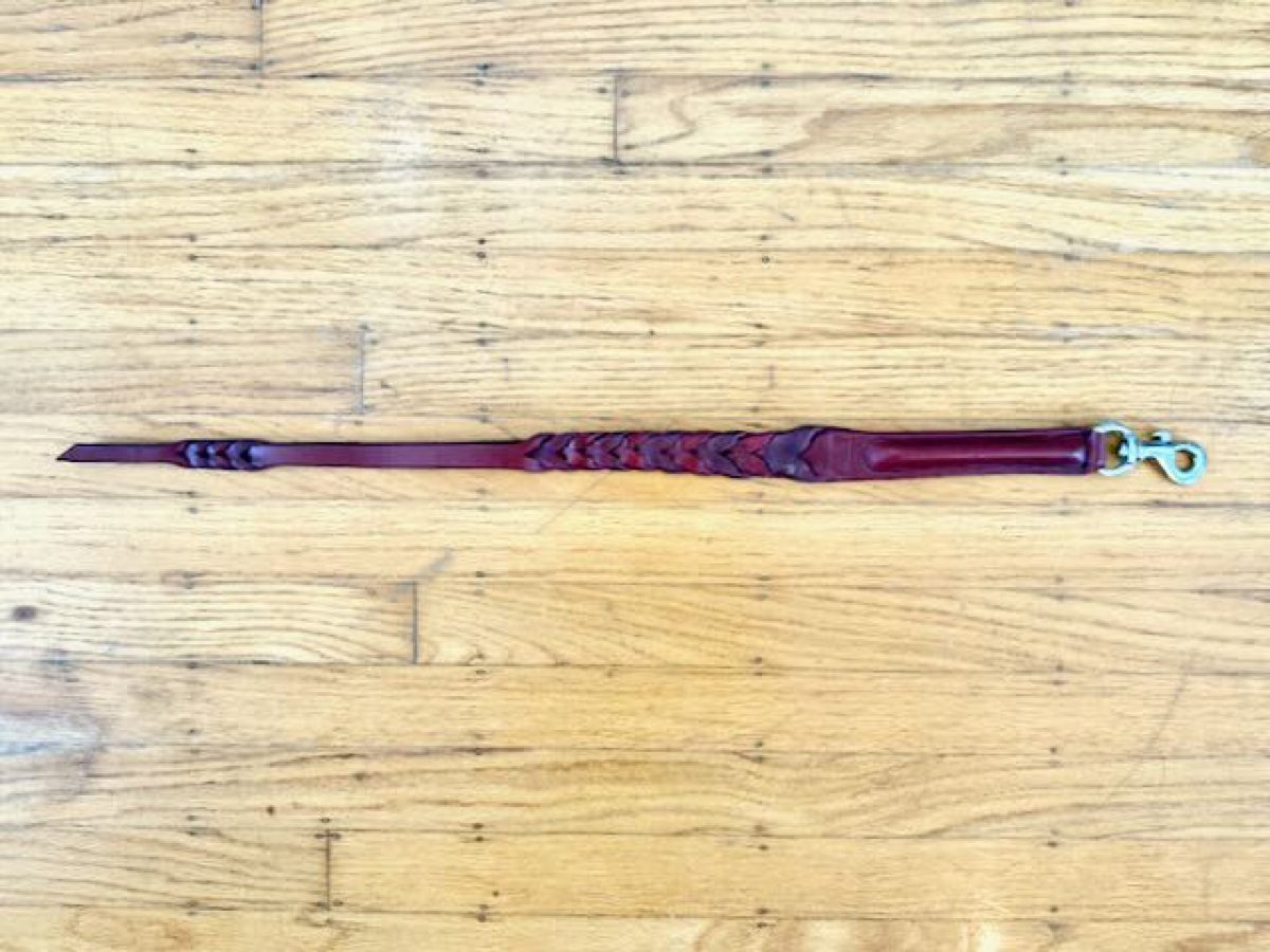 Leather braided quirt with a semi-rigid handle